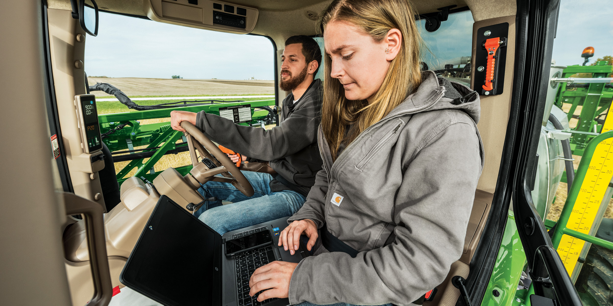 Farmer using laptop to clear codes in tractor